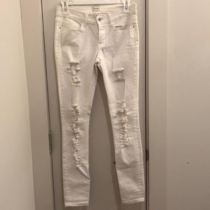 Distressed white skinny jeans